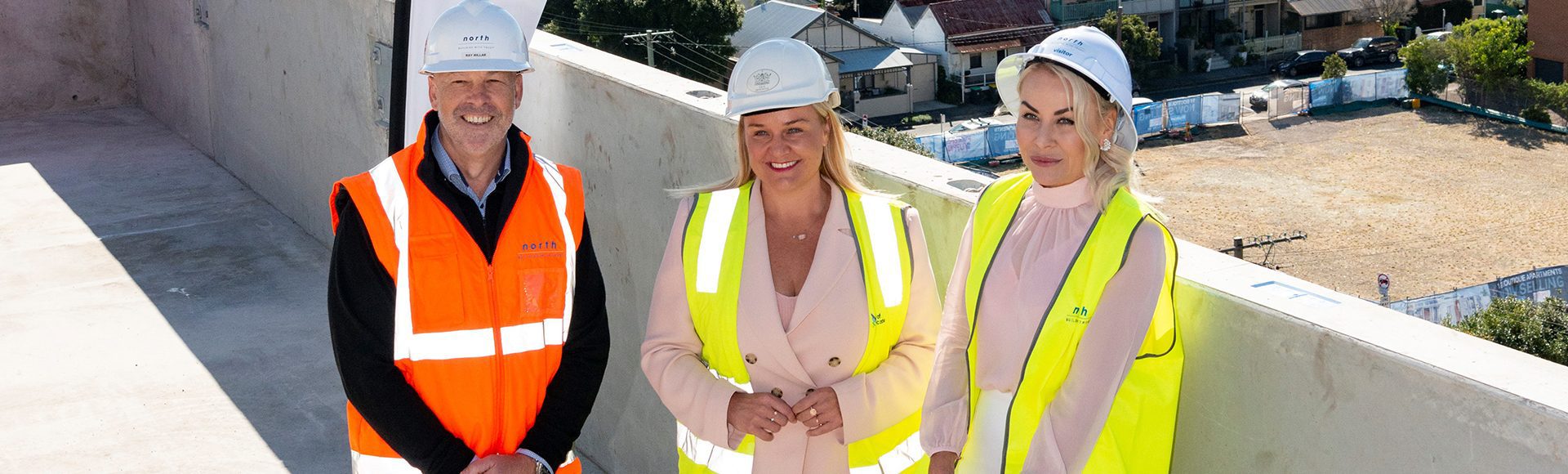 Three people inspecting a Home in Place complex that is nearly complete
