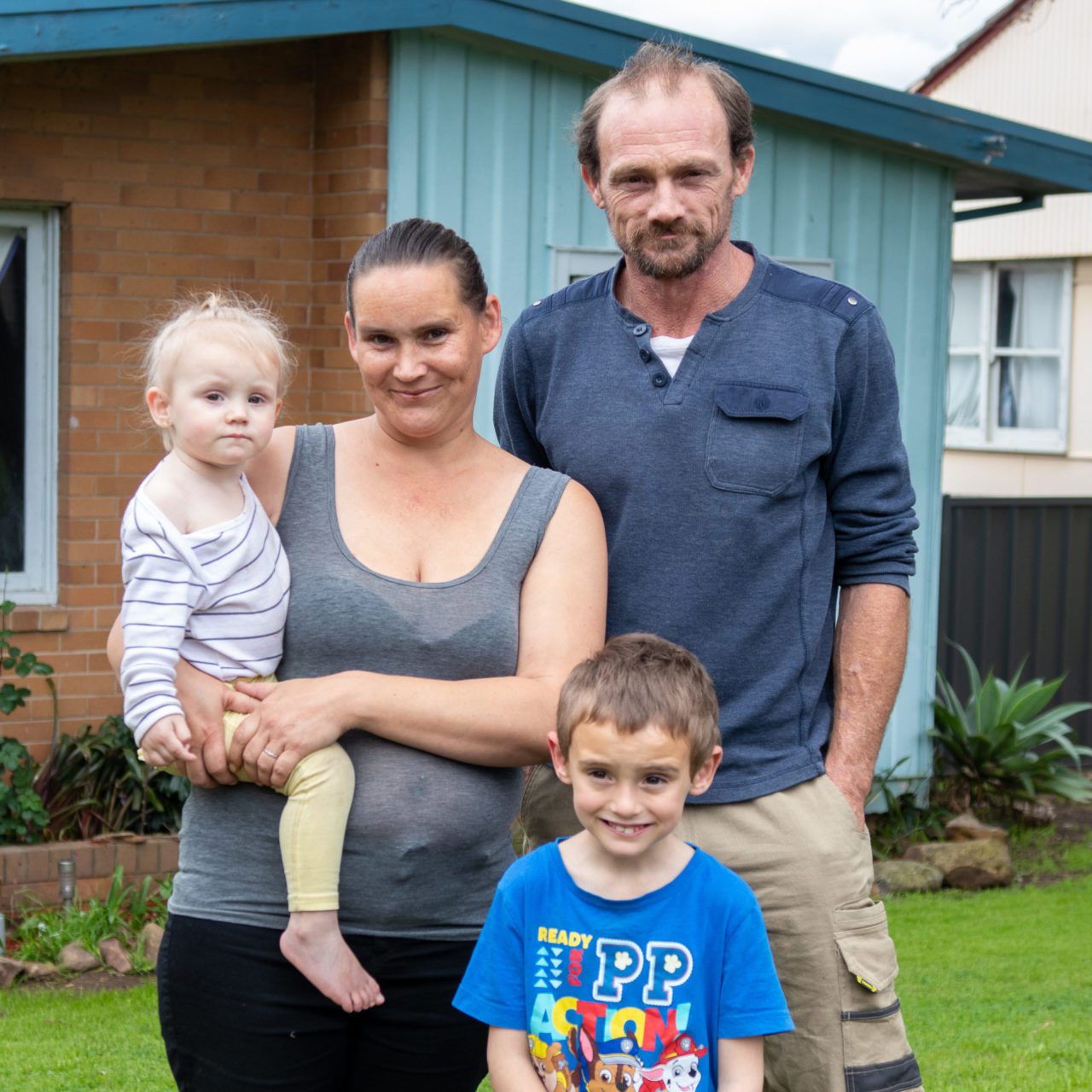 Family standing in front of their house