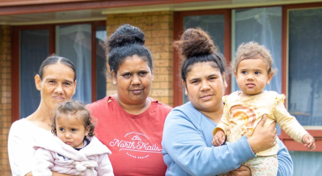 Group of people in front of a house