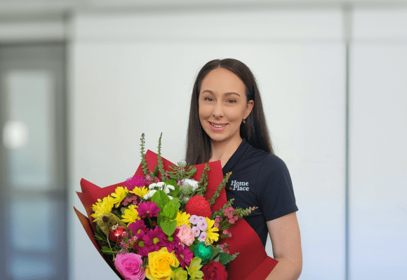 Woman holding a bunch of flowers in an office