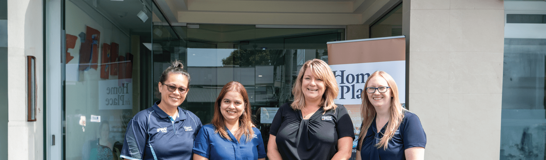Four women standing in front of an office