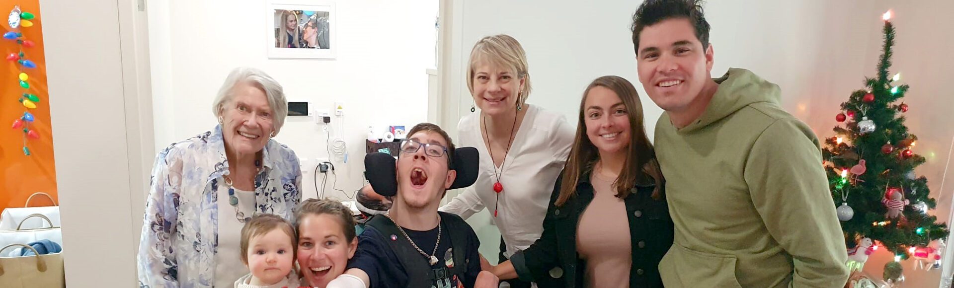 A family of seven in a loungeroom