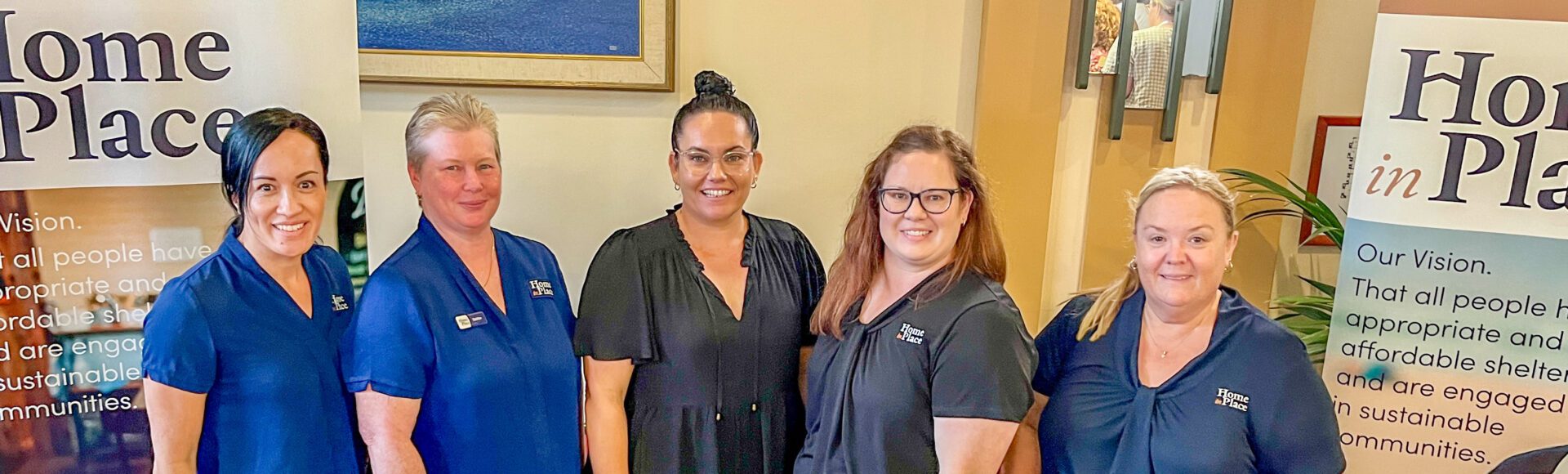 Group of five women behind an exhibition desk