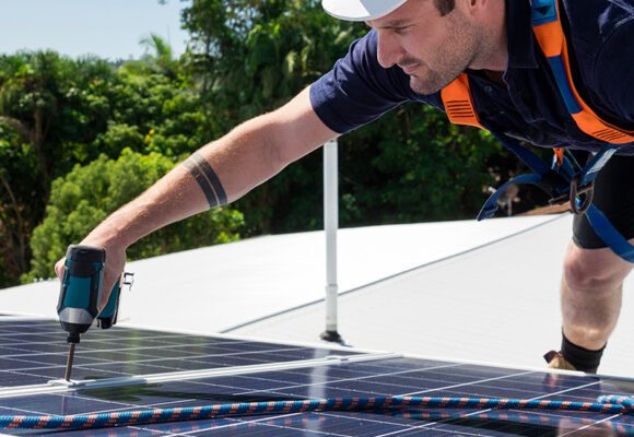 Man on a roof installing solar panels