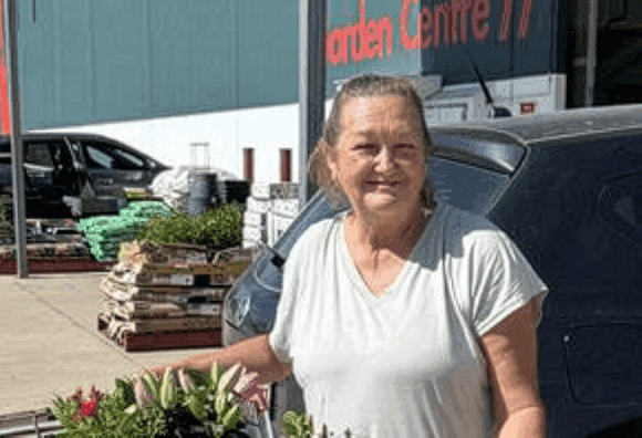 Woman with a trolley of plants in front of Bunnings