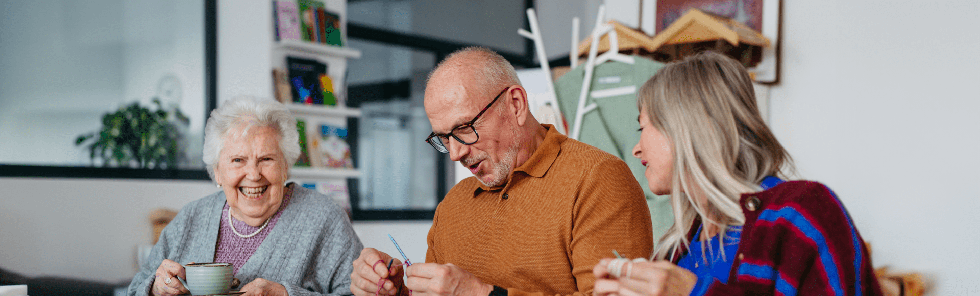 Group of people laughing and knitting
