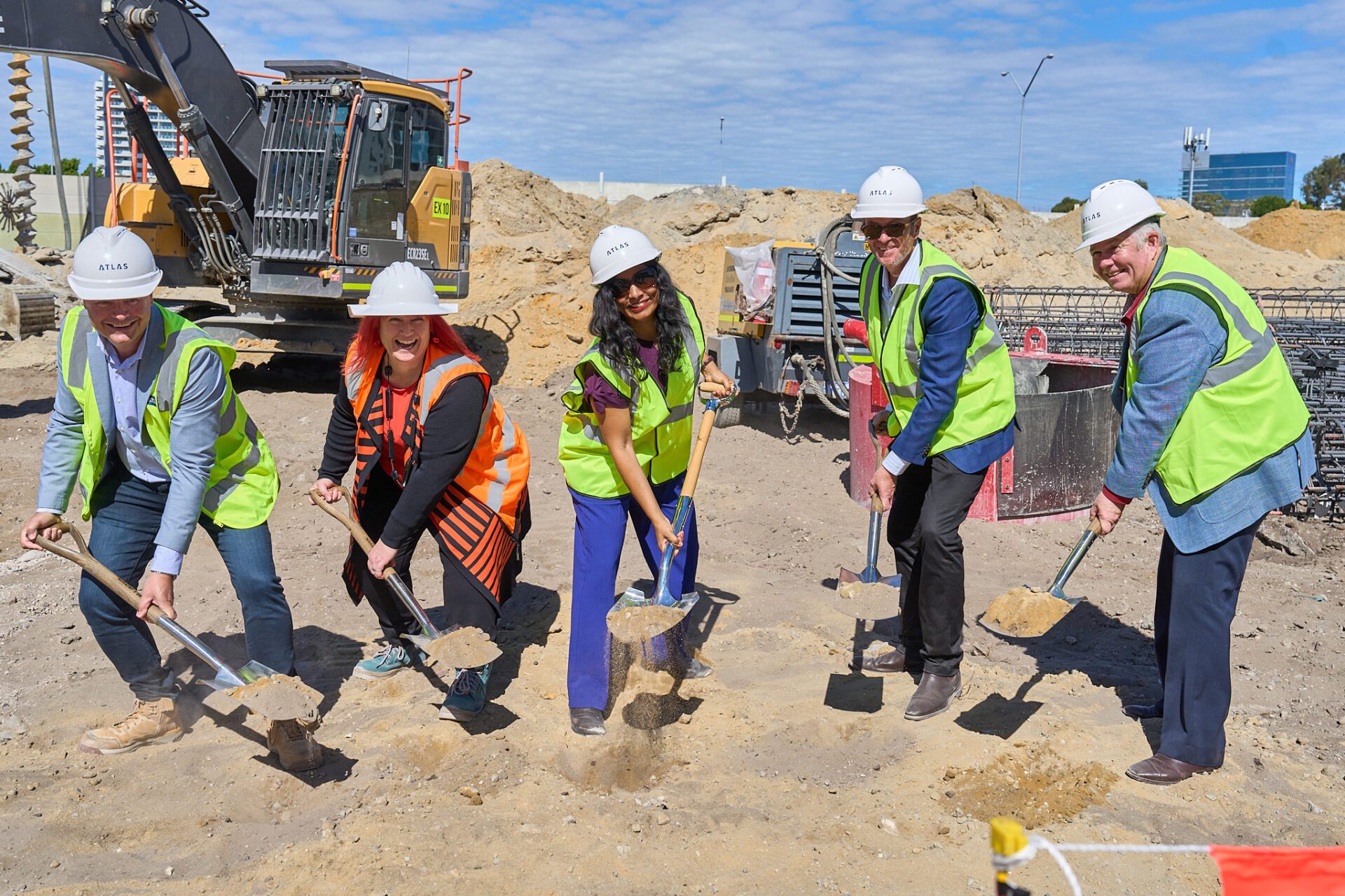 Group of five people with shovels on a construction site