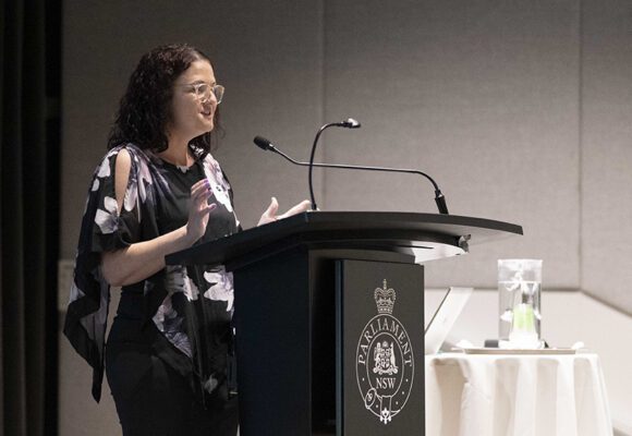 Side view of woman at a podium speaking