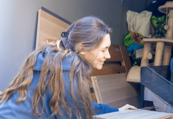 Woman stacking furniture and household items