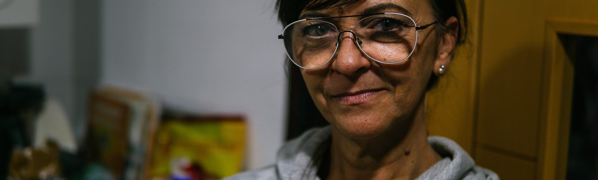 Woman inside her home looking at the camera